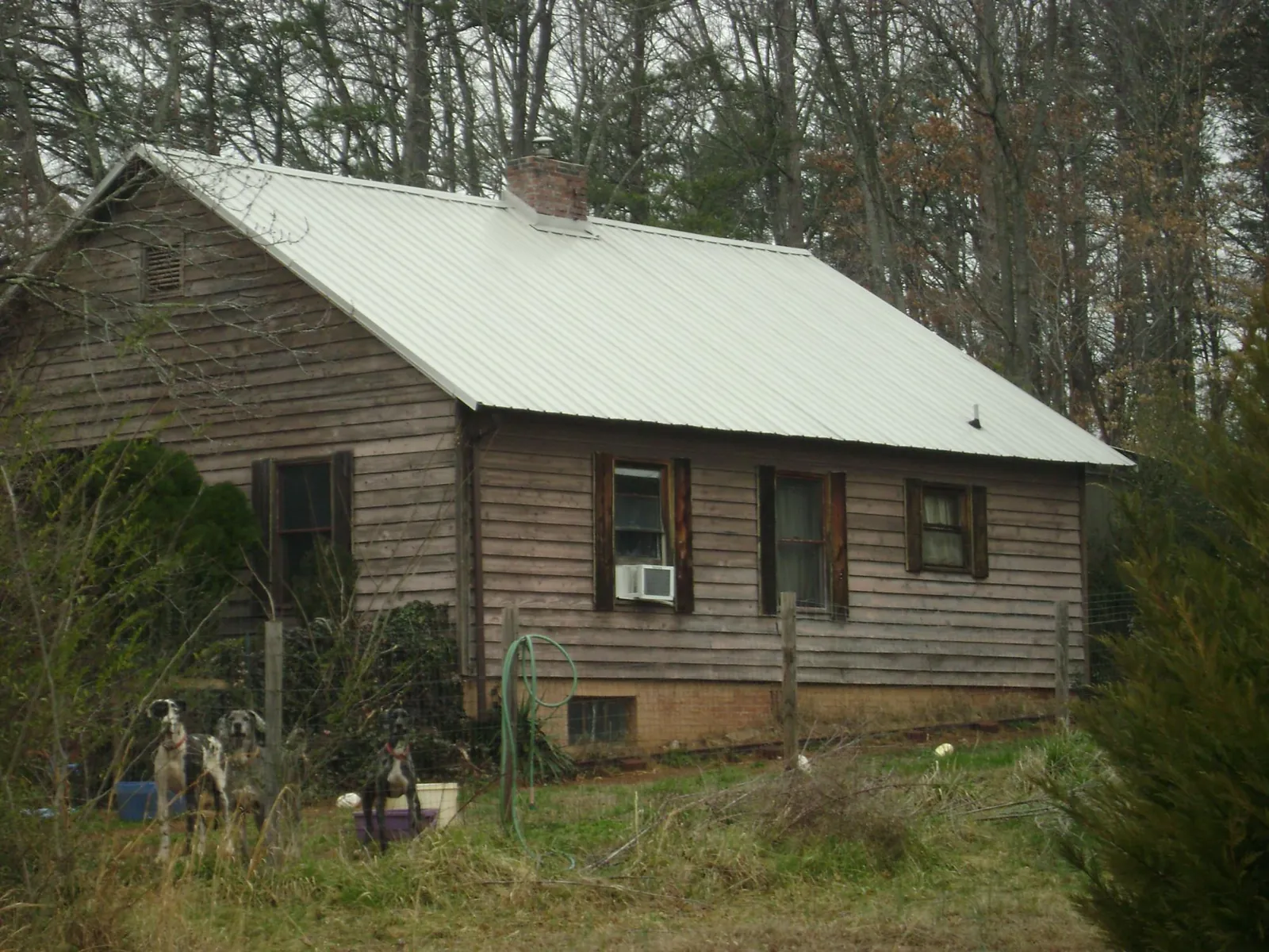 White metal roof on an old wood sided farmhouse, from a Metal Roof Installation job in Amanda